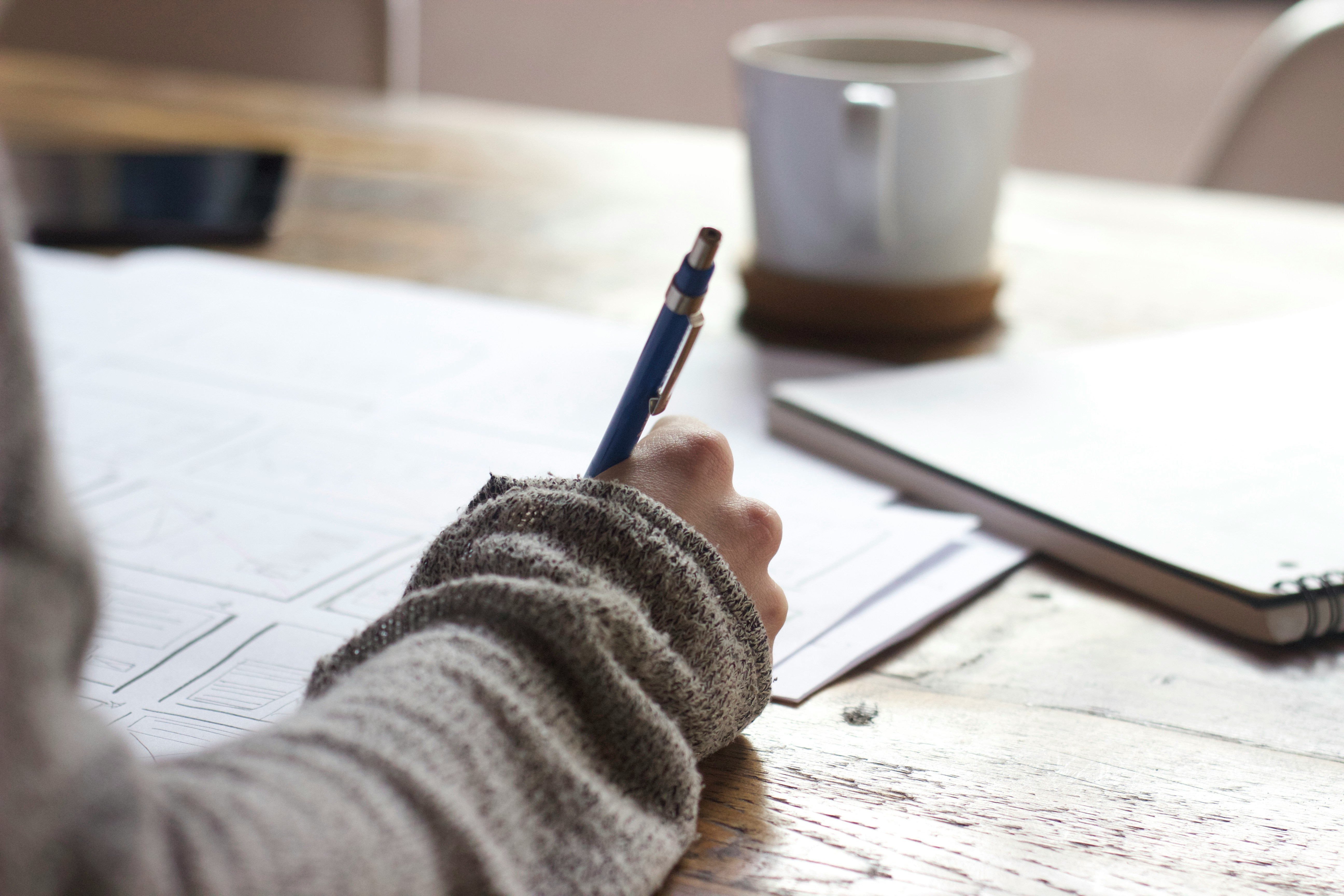 A person writing on a contract or document.